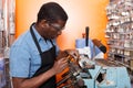 Confident man making key copies on bench machine Royalty Free Stock Photo