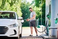 Confident man refueling his luxury auto.