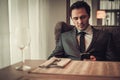 Confident man with smart phone in restaurant. Royalty Free Stock Photo