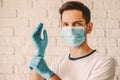 Confident doctor wearing sterile gloves and medical face mask Royalty Free Stock Photo