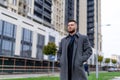 Confident man walking down the street. Young tourist looking into modern city Royalty Free Stock Photo