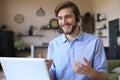 Confident man wearing headset speaking and watching business webinar training, listening to lecture Royalty Free Stock Photo