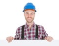 Confident manual worker holding billboard Royalty Free Stock Photo