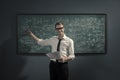 Confident math professor teaching in front of the chalkboard