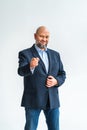 Confident mature bald businessman pointing with finger at camera and smiling Royalty Free Stock Photo