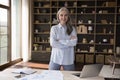 Confident mature elderly business woman standing at work table Royalty Free Stock Photo