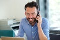 Confident mature guy talking on mobile phone and smiling Royalty Free Stock Photo