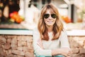 Confident mature woman relaxing in the garden at home Royalty Free Stock Photo