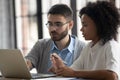 Confident mentor teaching African American businesswoman, helping with software Royalty Free Stock Photo