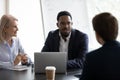 Confident mentor giving lecture to interns on corporate meeting Royalty Free Stock Photo