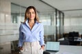 Middle aged business woman standing in office looking at camera. Portrait. Royalty Free Stock Photo