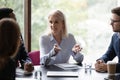 Confident middle-aged businesswoman head meeting with coworkers