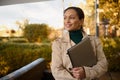 Confident middle aged beautiful woman, freelance, business person working on laptop, standing in the outdoor cafe on at beautiful Royalty Free Stock Photo