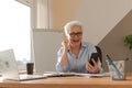 Confident middle aged senior woman euphoric winner with smartphone. Older mature lady looking at cell phone reading Royalty Free Stock Photo