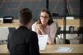 Confident millennial female applicant talking at job interview a Royalty Free Stock Photo