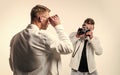 confident model photographer. twins brother in white. photographing. beauty and fashion Royalty Free Stock Photo