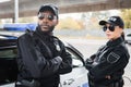 Confident multicultural police officers with crossed