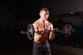 Confident muscular man training with barbell . Closeup portrait of professional bodybuilder workout with barbell at gym. Royalty Free Stock Photo