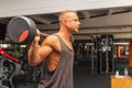 Confident muscular man training squats with barbells over head. Side view Closeup portrait of professional bodybuilder Royalty Free Stock Photo