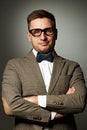 Confident nerd in eyeglasses and bow tie