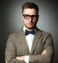 Confident nerd in eyeglasses and bow tie