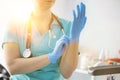 Confident nurse wearing gloves in hospital