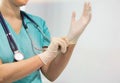 Confident nurse wearing gloves in hospital