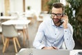 Confident office assistant answering the phone call Royalty Free Stock Photo