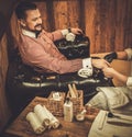 Confident old-fashioned man doing male manicure in a Barber shop.