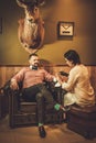 Confident old-fashioned man doing male manicure in a Barber shop.