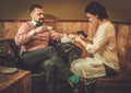 Confident old-fashioned man doing male manicure in a Barber shop.