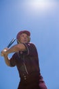Confident player with baseball bat against sky Royalty Free Stock Photo