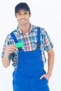 Confident plumber showing green card