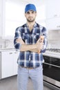 Confident plumber is standing in the kitchen Royalty Free Stock Photo