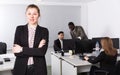 Confident positive businesswoman in office