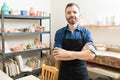 Confident Pottery Maker Wearing Apron In Workshop Royalty Free Stock Photo