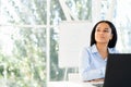 Confident pretty black businesswoman in a bright modern office looking to copy space