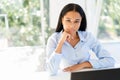 Confident pretty black businesswoman in modern office with copy space