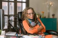 Confident Woman with Drealocks at Her Desk