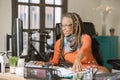 Confident Woman with Drealocks Working at Her Desk