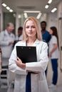 Confident Professional Female Doctor Posing At Camera Holding Clipboard in Hands Royalty Free Stock Photo