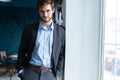 Confident professional handsome businessman standing near window in his office Royalty Free Stock Photo