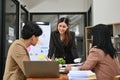 Confident Asian female marketing manager leads the meeting, discussing with her team Royalty Free Stock Photo