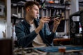 technician restores the laptop PC, examining disassembled parts of laptop.at repair shop