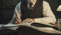 Academic professor writing down notes and reading a book Royalty Free Stock Photo