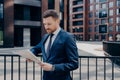 Confident proud CEO dressed in elegant wear reading business publication on early morning Royalty Free Stock Photo