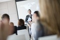 Confident public speaker looking at audience applauding during seminar Royalty Free Stock Photo