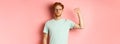 Confident redhead man standing united with black lives matter movemet, showing raised fist and looking serious at camera