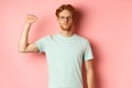 Confident redhead man standing united with black lives matter movemet, showing raised fist and looking serious at camera