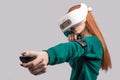 Confident redhead woman wearing virtual reality headset, aiming from the bow Royalty Free Stock Photo